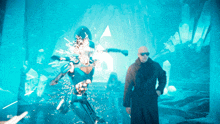 a man in a black coat is standing in front of a blue background that says #superhero on it