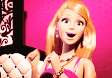a barbie doll with a surprised look on her face is sitting on a chair