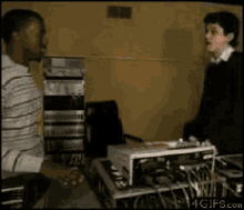 two men are dancing in a room with a 4gifs.com logo on the bottom