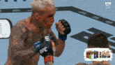 a man in a ufc glove holds his fist up