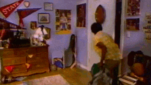 a man is standing in a bedroom with a dresser and a flag that says state on it .