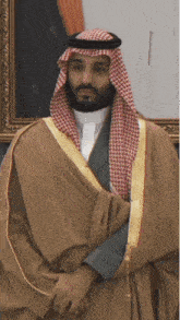 a man with a beard wearing a traditional arabian costume