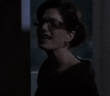 a woman is screaming in a dark room
