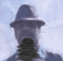 a blurry picture of a man wearing a hat and a suit