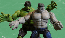 two hulk action figures standing next to each other