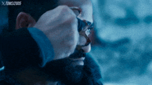 a close up of a man 's face with a toms / 2005 watermark