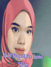 a woman wearing a pink hijab with the words ' hadir support team haniez ' on the bottom