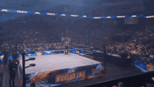 a sign that says ospreay still better is held up in a crowd