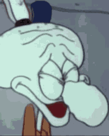 squidward from spongebob squarepants is making a funny face with his tongue out .