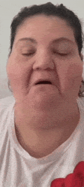 a close up of a woman 's face with her eyes closed and her mouth open .