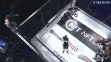 an aerial view of a boxing ring with a nft lab banner