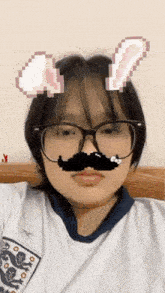 a girl wearing glasses and a fake mustache is taking a selfie .