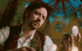 a man is holding a pocket watch in his hand