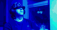 a man wearing headphones and a hat that says ' supreme ' on it