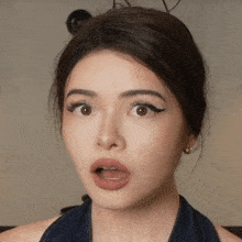 a close up of a woman making a surprised face