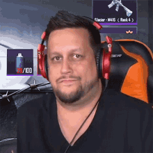 a man wearing headphones is sitting in an orange chair