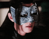 a close up of a person wearing a mask that has a cat on it