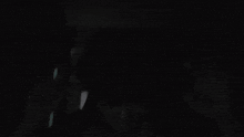 a person 's head is visible in the dark in a black and white photo .