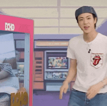 a man wearing a rolling stones shirt is standing in front of a echo machine