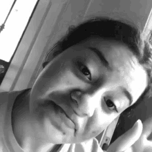 a black and white photo of a woman making a silly face