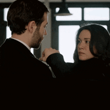 a man and a woman looking at each other