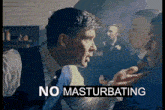 a man in a suit and tie is talking to another man with the words no masturbating above him .