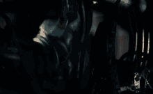 a close up of a person wearing a batman mask and sunglasses .