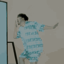 a man wearing a shirt that says adidas is jumping in the air .