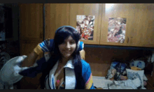 a woman wearing headphones and a blue jacket is being held by a man