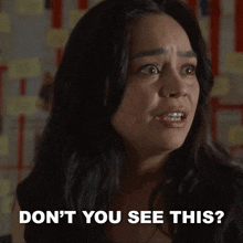 a close up of a woman 's face with the words " do n't you see this " above her