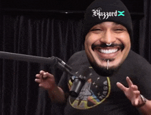 a man wearing headphones is laughing in front of a microphone and saying `` hahaha '' .
