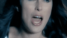 a close up of a woman 's mouth with her tongue out