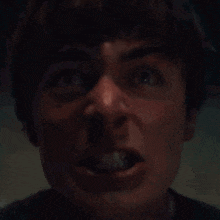 a close up of a man screaming with his mouth wide open