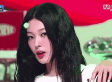 a close up of a woman 's face with the word mnet on the bottom