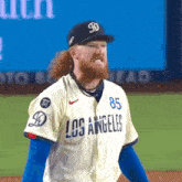 a man wearing a los angeles jersey stands on the field