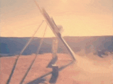 a rocket is being launched into the air at sunset .