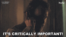 a man talking on a cell phone with the words " it 's critically important " above him