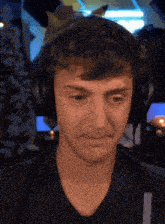 a man is wearing headphones and making a face