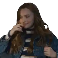 a woman wearing a striped shirt and a denim jacket is covering her mouth with her hand