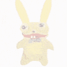 a stuffed animal with a purple bow tie and big eyes