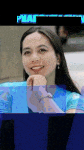 a woman wearing a blue shirt and a watch is smiling with the word phat in the corner