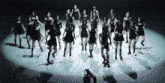 a group of women are dancing on a stage
