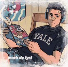 a man wearing a yale shirt is reading a comic