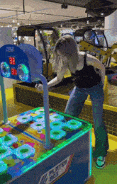 a woman playing a game called player box