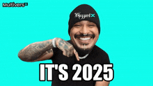 a man wearing a hat that says blizzard on it is smiling and says it 's 2025