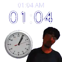 a man stands in front of a clock that says 1:04