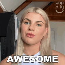 a blonde woman says awesome in front of a hanger