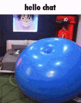 a blue balloon with a hole in the middle is sitting in a bedroom with a picture of monkey d luffy on the wall