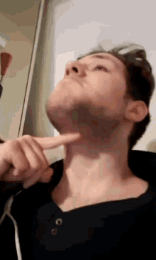 a man with his finger on his chin looks up