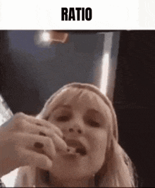 a woman is eating a piece of food with a spoon .
